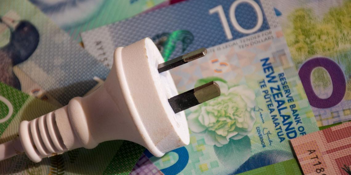 A NZ plug sitting on top of a pile of money