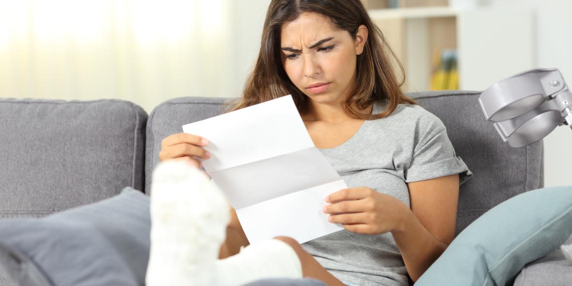 Woman stares a piece of paper and looks confused