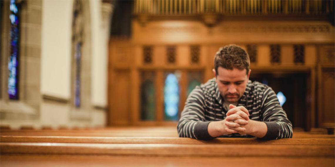a man praying in a church
