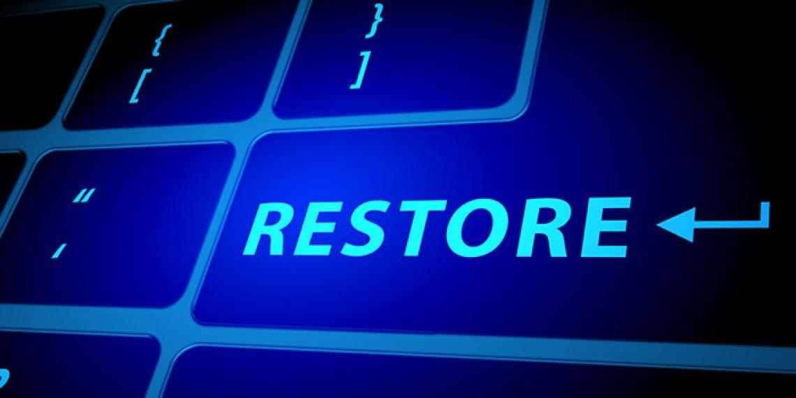 a computer keyboard spelling the word restore